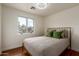 Calm bedroom with a natural light and light colored walls and bedspread at 4026 E Captain Dreyfus Ave, Phoenix, AZ 85032