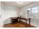 Bedroom with a wooden desk, a large window with a view, and light hardwood floors at 4026 E Captain Dreyfus Ave, Phoenix, AZ 85032