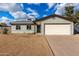 Well-maintained home features a two-car garage and desert landscaping for easy care at 4026 E Captain Dreyfus Ave, Phoenix, AZ 85032