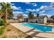 Backyard features a sparkling pool, luscious green lawn and mature shade trees at 4026 E Captain Dreyfus Ave, Phoenix, AZ 85032