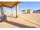 Covered patio with desert landscaping in the backyard at 4130 N Del Monte Dr, Eloy, AZ 85131