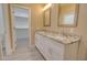 Bathroom with double sinks, granite counters, and a view into the walk-in closet at 4130 N Del Monte Dr, Eloy, AZ 85131