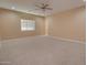 Spacious bedroom with neutral carpet, ceiling fan, and a large window at 4130 N Del Monte Dr, Eloy, AZ 85131