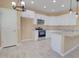 Bright kitchen featuring white cabinets, granite counters, and stainless steel appliances at 4130 N Del Monte Dr, Eloy, AZ 85131