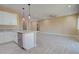 The living room flows into a modern kitchen featuring an island and stainless appliances at 4130 N Del Monte Dr, Eloy, AZ 85131