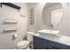 Stylish half-bathroom featuring modern vanity with vessel sink and decorative shelving at 41955 W Hillman Dr, Maricopa, AZ 85138