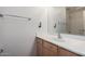 Bathroom featuring a single sink with a wood cabinet, framed mirror, and chrome fixtures and hardware at 41955 W Hillman Dr, Maricopa, AZ 85138