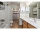 A full bathroom with a sink vanity, shower-tub combo and access to a large walk-in closet at 41955 W Hillman Dr, Maricopa, AZ 85138