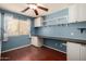 Bright bedroom features a built-in desk, shelving and wood flooring at 41955 W Hillman Dr, Maricopa, AZ 85138