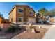 Two-story home featuring desert landscaping, a two car garage, and a driveway at 41955 W Hillman Dr, Maricopa, AZ 85138