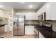 Modern kitchen featuring stainless steel appliances and mosaic backsplash at 41955 W Hillman Dr, Maricopa, AZ 85138