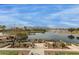 Stunning lake view with outdoor seating areas and mountain views in the distance at 42368 W North Star Dr, Maricopa, AZ 85138