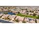 Panoramic aerial of a residential neighborhood with a lake, green spaces, and many single-Gathering homes at 42368 W North Star Dr, Maricopa, AZ 85138