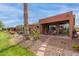 Charming backyard patio with desert landscaping, stone pathway and covered seating area at 42368 W North Star Dr, Maricopa, AZ 85138