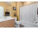 Cozy bathroom includes a tiled shower, with a decorative shower curtain and a wooden vanity at 42368 W North Star Dr, Maricopa, AZ 85138