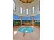 Luxurious indoor hot tub features a mural, arched windows, and tile flooring for a relaxing spa-like experience at 42368 W North Star Dr, Maricopa, AZ 85138