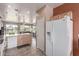 Bright kitchen with tile floors, white appliances, and a view into the living room at 42368 W North Star Dr, Maricopa, AZ 85138