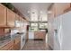 Open kitchen design featuring tile floors, white appliances, and views into the living space at 42368 W North Star Dr, Maricopa, AZ 85138