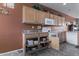 Kitchen with wooden cabinets and pull out shelving for easy storage at 42368 W North Star Dr, Maricopa, AZ 85138