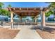 Covered picnic area with tables, bike rack, and access to tennis courts, ideal for community gatherings at 42368 W North Star Dr, Maricopa, AZ 85138