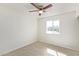 Bedroom features ceiling fan, wood-look floors, and a window overlooking the front yard at 4366 E Burgess Ln, Phoenix, AZ 85042