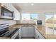 Updated kitchen featuring granite countertops, stainless steel appliances, and white cabinets at 4366 E Burgess Ln, Phoenix, AZ 85042