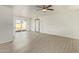 Bright living room with neutral paint, modern ceiling fan, and sliding glass door to the backyard at 4366 E Burgess Ln, Phoenix, AZ 85042