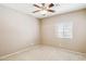 Bright bedroom features tan walls, beige carpet flooring, and a window with blinds for natural light at 455 S Mesa Dr # 126, Mesa, AZ 85210