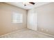 Bedroom features a window with blinds, neutral-colored walls, beige carpet, and a white closet at 455 S Mesa Dr # 126, Mesa, AZ 85210