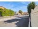 Gated entrance to the community with lush greenery and a clear blue sky at 455 S Mesa Dr # 126, Mesa, AZ 85210