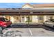 View of covered parking and the front of the building with desert landscaping at 455 S Mesa Dr # 126, Mesa, AZ 85210