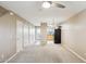 Spacious living room featuring beige walls, ceiling fan, and kitchen in background at 455 S Mesa Dr # 126, Mesa, AZ 85210