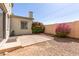 Paver patio with neutral stucco wall, bougainvillea, and low-maintenance desert landscaping at 4675 E Olney Ave, Gilbert, AZ 85234