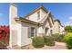 Two-story home with desert landscaping, a chimney, and shuttered windows under a clear, blue sky at 4675 E Olney Ave, Gilbert, AZ 85234