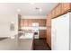 Kitchen with stone countertops, light wood cabinets, an island, and white appliances at 4675 E Olney Ave, Gilbert, AZ 85234