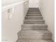 Carpeted staircase with white painted handrail and corbels leading to the upper level of the home at 4675 E Olney Ave, Gilbert, AZ 85234