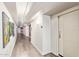 Well-lit hallway with wood-look flooring and modern wall decor at 535 W Thomas Rd # 313, Phoenix, AZ 85013