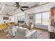 Bright living room featuring modern furnishings, ceiling fans, and expansive windows at 535 W Thomas Rd # 313, Phoenix, AZ 85013