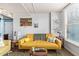 Bright living room with a yellow sofa, decor, and window views at 535 W Thomas Rd # 313, Phoenix, AZ 85013