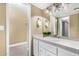 Bathroom featuring white cabinets, a sink, and an open doorway to a closet at 6159 E Indian School Rd # 110, Scottsdale, AZ 85251