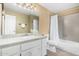 Bright bathroom featuring a shower-tub combo with a white vanity and tile countertop at 6159 E Indian School Rd # 110, Scottsdale, AZ 85251