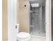 Bathroom featuring a clear glass shower, toilet, and light wood-look flooring at 6159 E Indian School Rd # 110, Scottsdale, AZ 85251