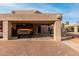 View of the home's exterior with a covered parking area and a yellow Ford Bronco at 6159 E Indian School Rd # 110, Scottsdale, AZ 85251