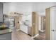 Well-lit kitchen featuring white cabinetry, granite countertops, and stainless steel appliances at 6159 E Indian School Rd # 110, Scottsdale, AZ 85251