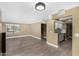 The living room with tile floors, view of the stairs, and a glimpse into the kitchen at 6159 E Indian School Rd # 110, Scottsdale, AZ 85251