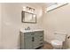 Bathroom with updated gray vanity and classic fixtures and white toilet at 632 Aero Rd, Mesa, AZ 85205