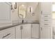 Bathroom featuring white cabinets with contrasting fixtures and a modern oval mirror at 632 Aero Rd, Mesa, AZ 85205