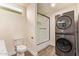 Modern bathroom with a stacked washer and dryer and glass-enclosed shower at 632 Aero Rd, Mesa, AZ 85205