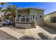 Charming home exterior with a private driveway, complemented by mature trees and manicured landscaping at 632 Aero Rd, Mesa, AZ 85205