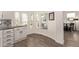 This kitchen features white cabinetry, wood flooring, and a nook area for dining at 632 Aero Rd, Mesa, AZ 85205